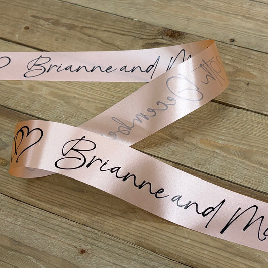 Personalised wedding car ribbon in peach with black print.
