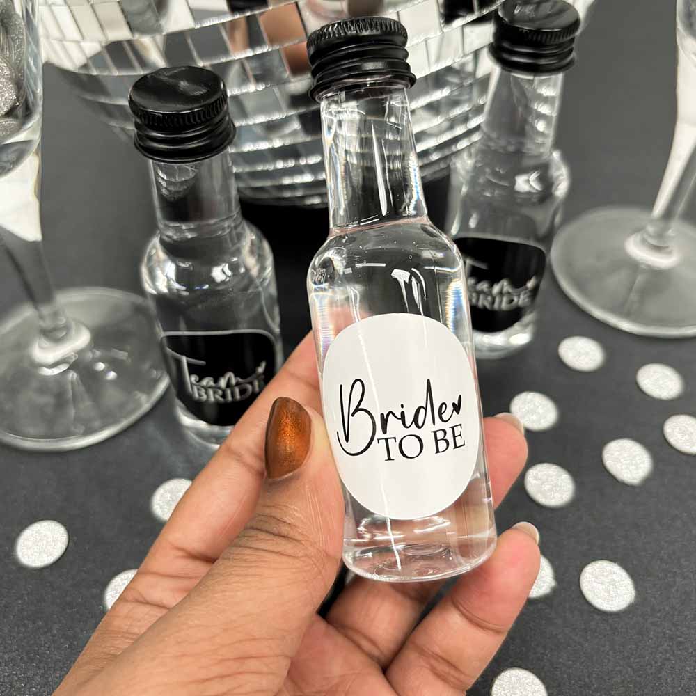 Hand holding a Bride to Be Hen Party Shot Bottle.