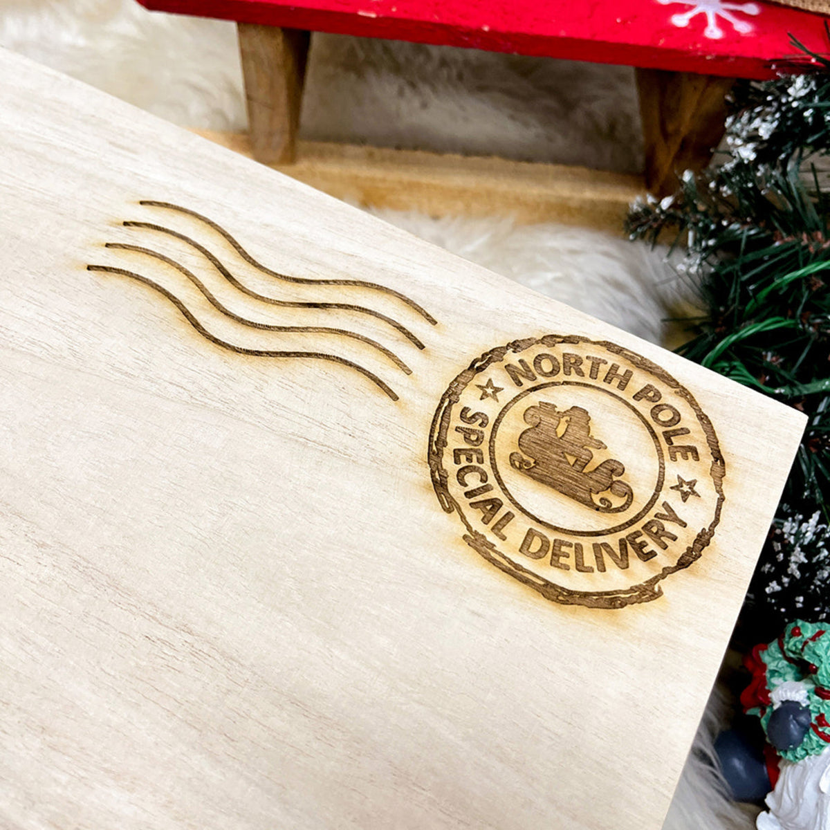 A close up of a personalised Christmas Eve Box showing the delivery postmark of Santa in his sleigh. 