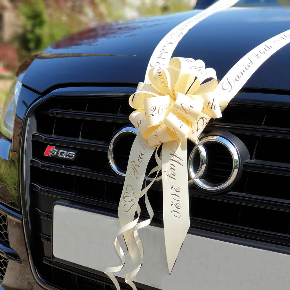 A car dressed with a personalised wedding car ribbon kit