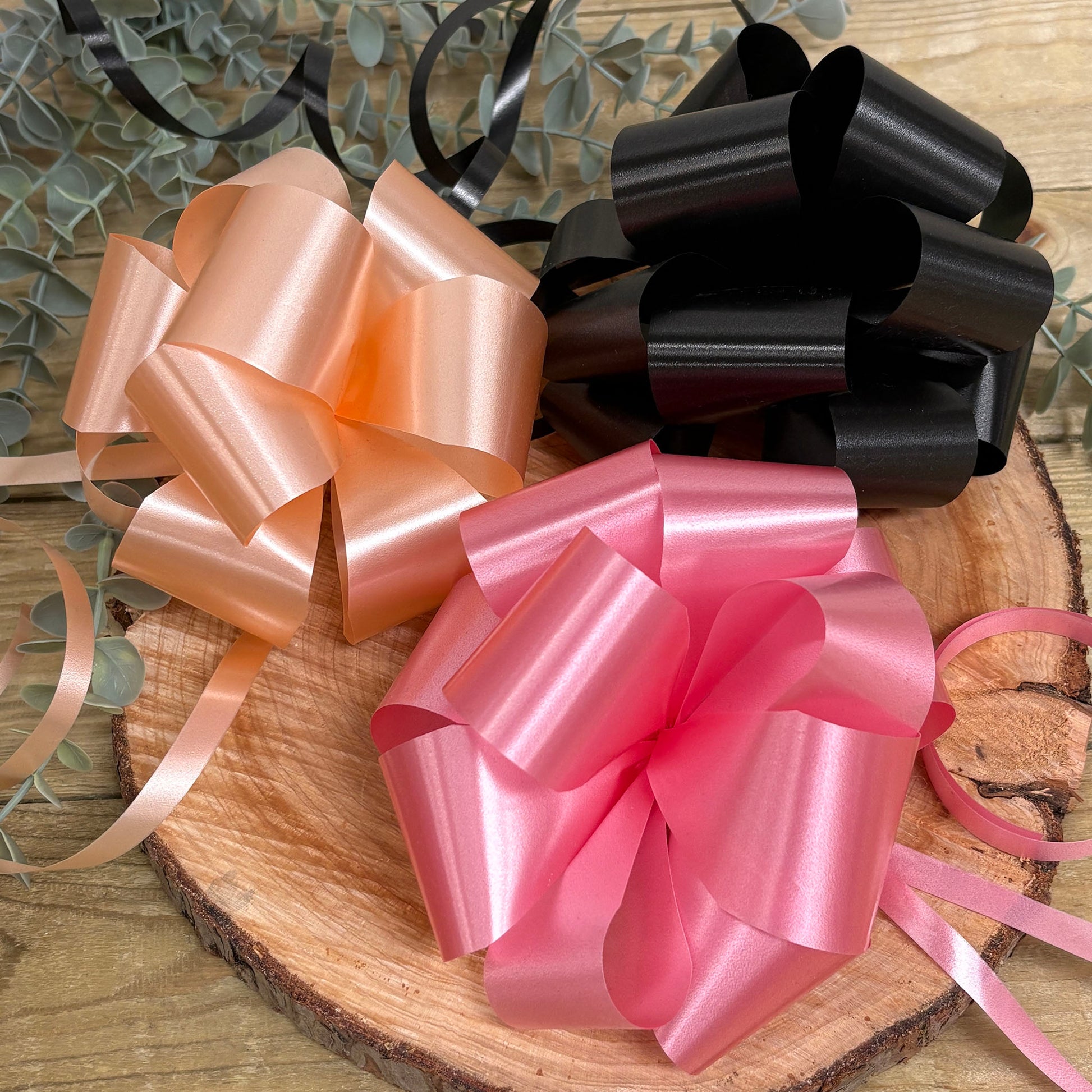 Plain handmade wedding car door bows in peach, rose pink and black.