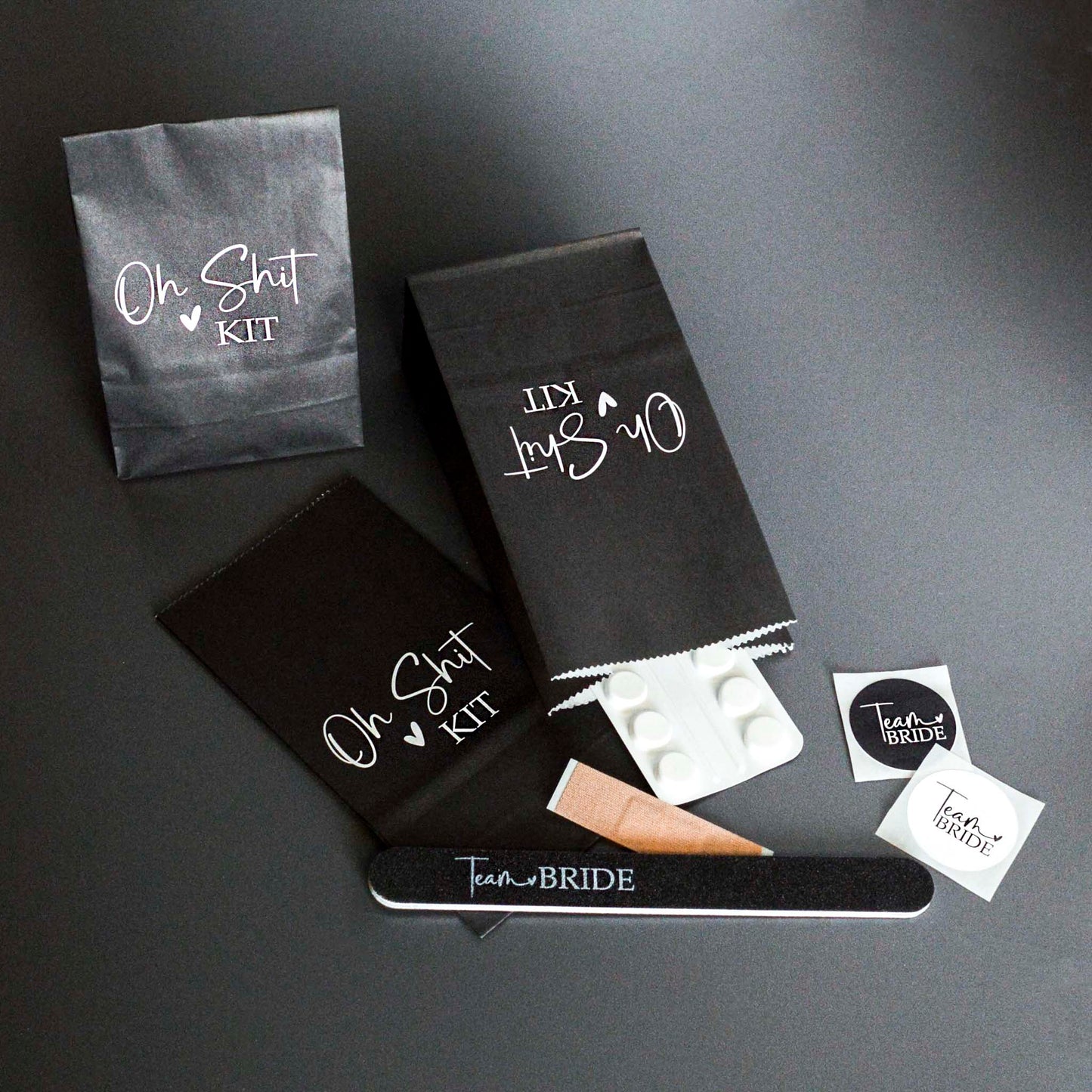 A set of black Team Bride Hen Party Hangover Kit Bags with suggested fillings. 