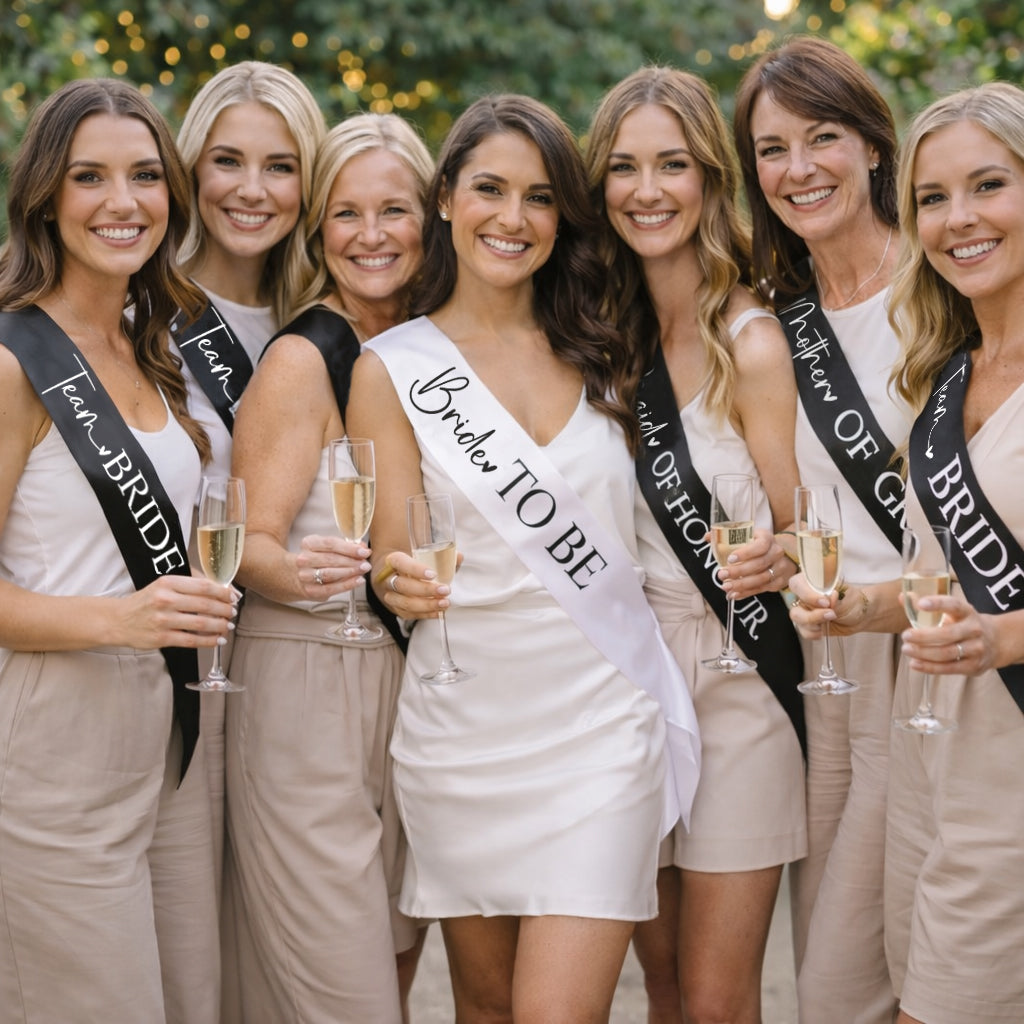 Group of women with Team Bride sashes and champagne glasses, celebrating a bridal event.