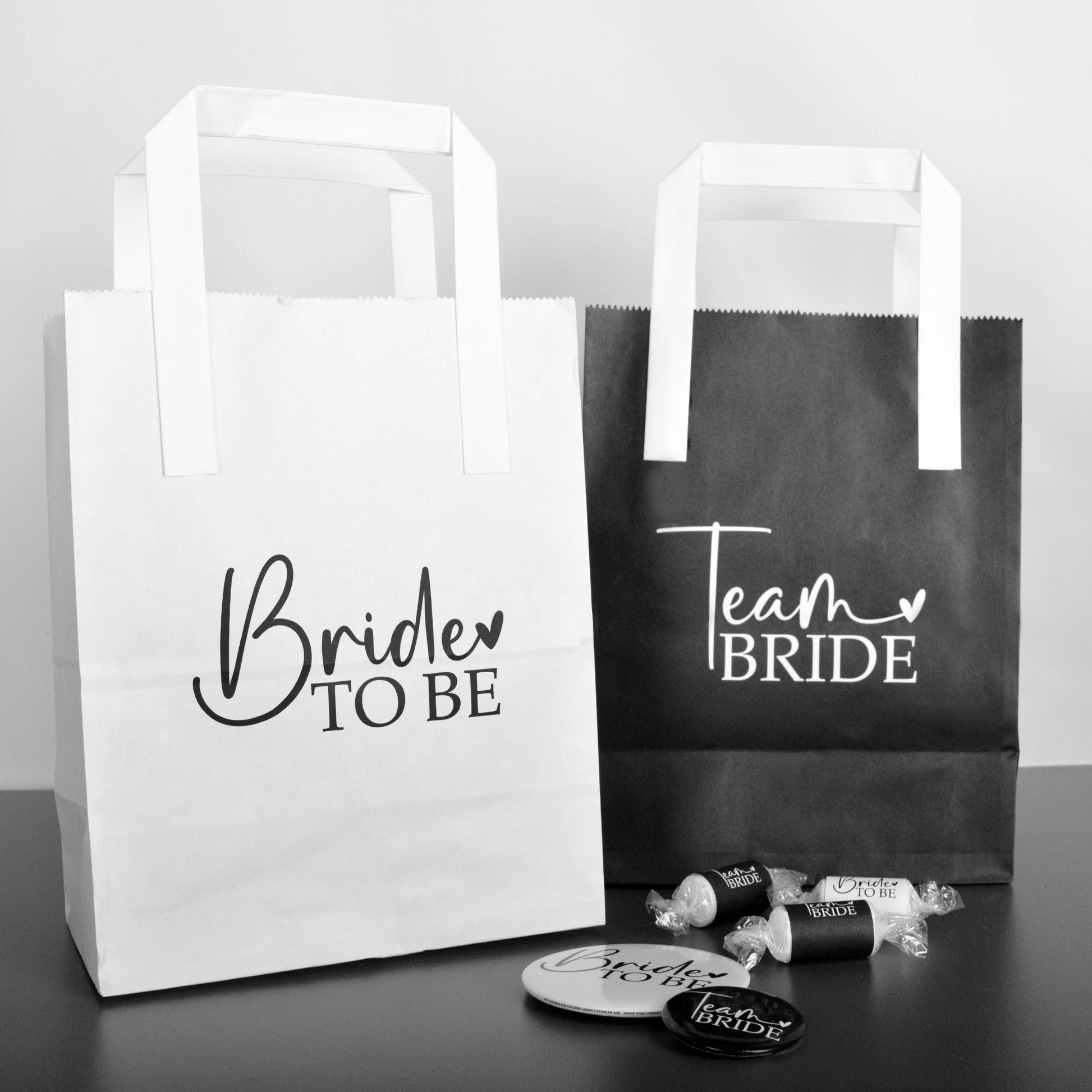 Black and white Team Bride Hen Party Goodie Bags, along with a white and black Bride to Be Hen Party Bag. 
